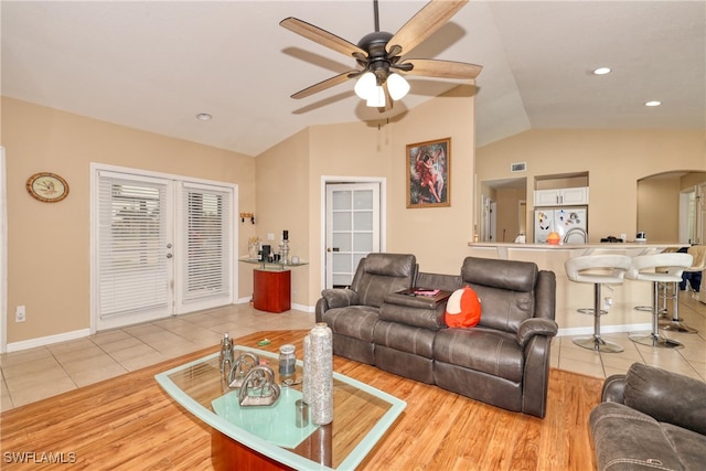 tiled living room with vaulted ceiling and ceiling fan