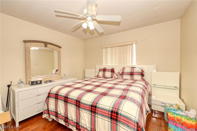 bedroom with ceiling fan and dark hardwood / wood-style flooring