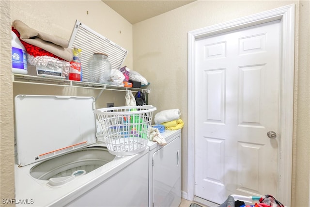 clothes washing area featuring washer and clothes dryer