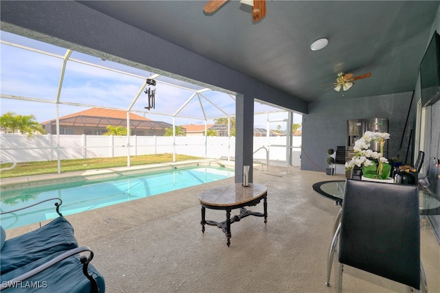 view of swimming pool with a lanai, ceiling fan, and a patio area