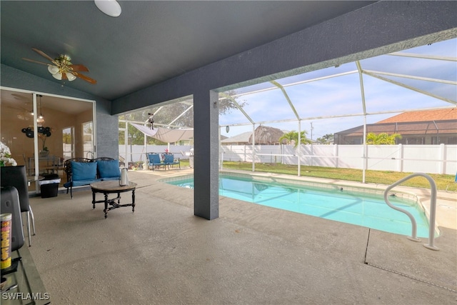 view of swimming pool with ceiling fan, a lanai, an outdoor living space, and a patio