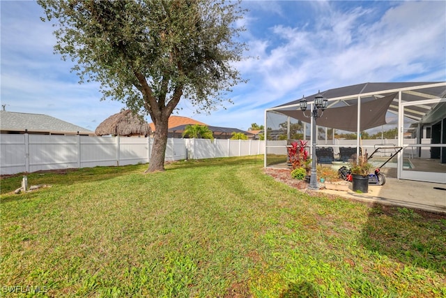 view of yard featuring a patio area and glass enclosure