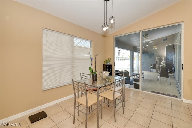 tiled dining area with lofted ceiling