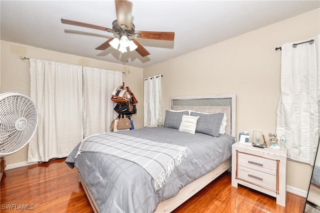 bedroom with ceiling fan and hardwood / wood-style floors