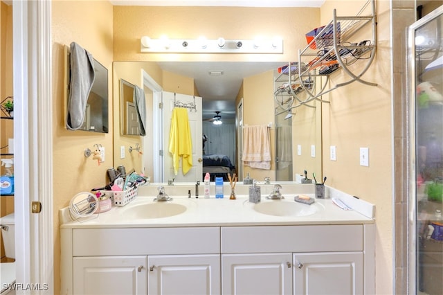 bathroom featuring toilet, ceiling fan, and vanity