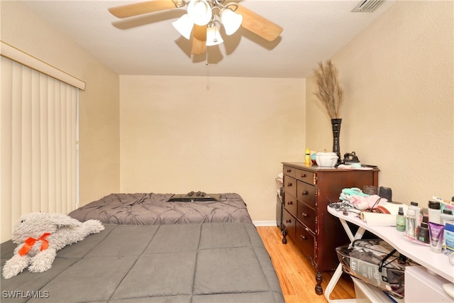 bedroom with ceiling fan and light hardwood / wood-style floors