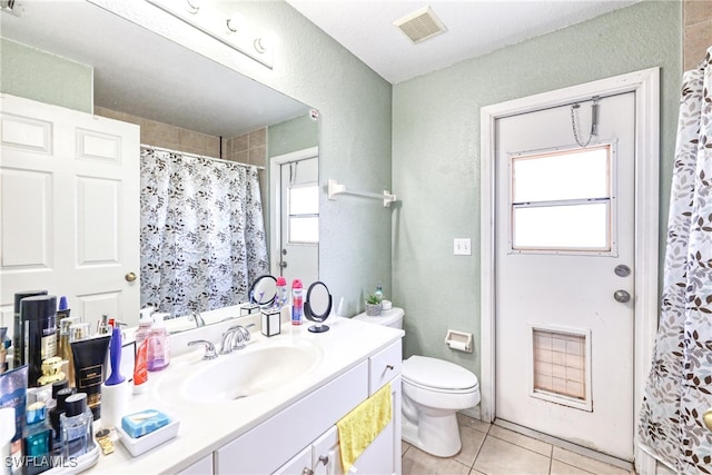 bathroom featuring toilet, tile patterned flooring, a shower with curtain, and vanity