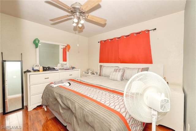 bedroom with ceiling fan and hardwood / wood-style floors