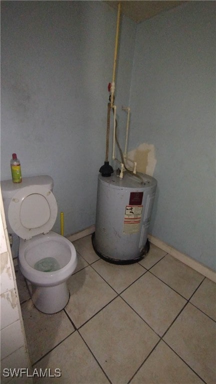 bathroom with tile patterned flooring, toilet, and water heater