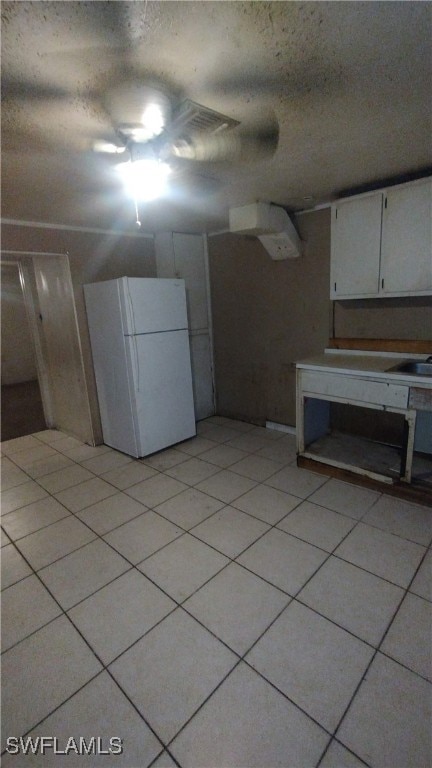 basement with white refrigerator