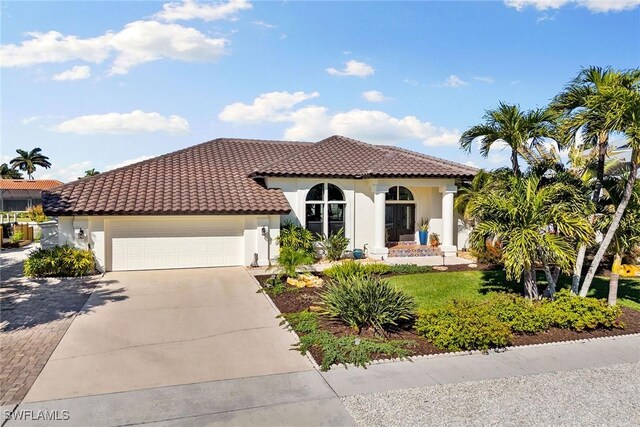 mediterranean / spanish house with a garage