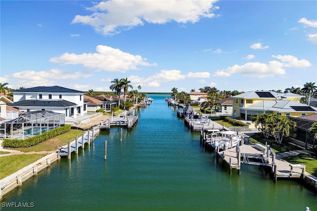 view of dock featuring glass enclosure and a water view