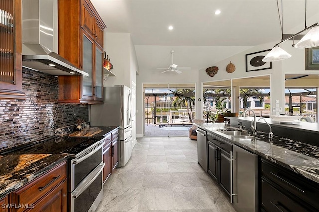 kitchen featuring backsplash, sink, wall chimney exhaust hood, ceiling fan, and stainless steel appliances