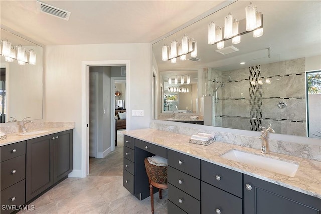 bathroom with a wealth of natural light, vanity, and a shower with shower door