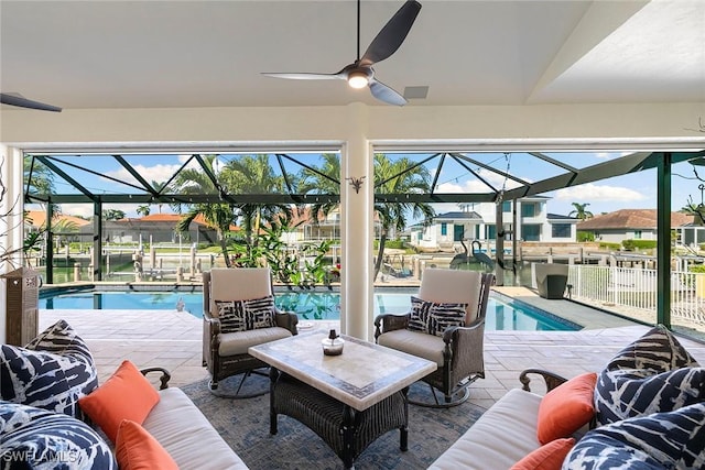 view of swimming pool with a patio area, ceiling fan, and a lanai