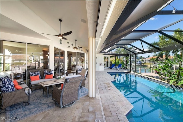 view of swimming pool featuring a lanai, outdoor lounge area, ceiling fan, and a patio