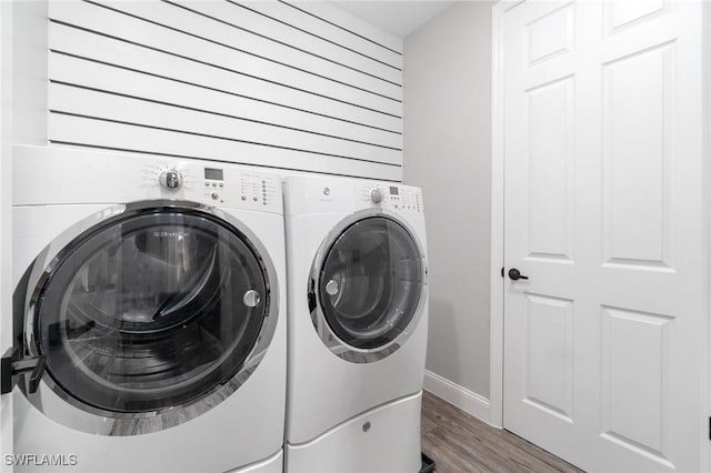 laundry area featuring washer and clothes dryer and dark hardwood / wood-style floors