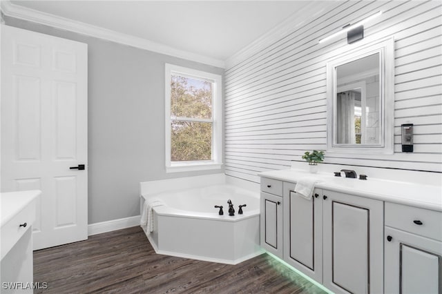 bathroom featuring a washtub, hardwood / wood-style floors, vanity, and ornamental molding