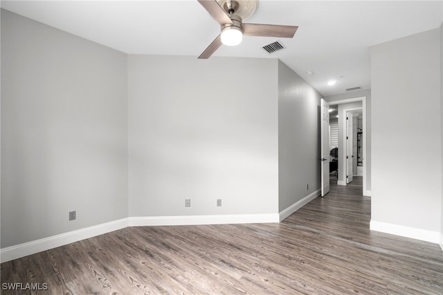 empty room with ceiling fan and dark hardwood / wood-style floors