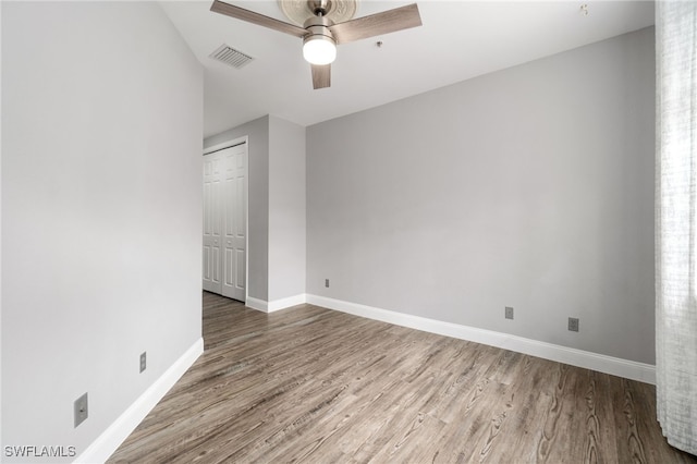 spare room with ceiling fan and hardwood / wood-style flooring