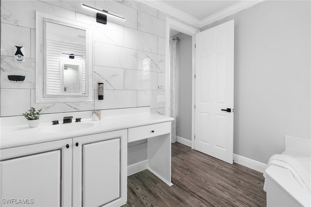 bathroom with hardwood / wood-style flooring, tile walls, vanity, and crown molding