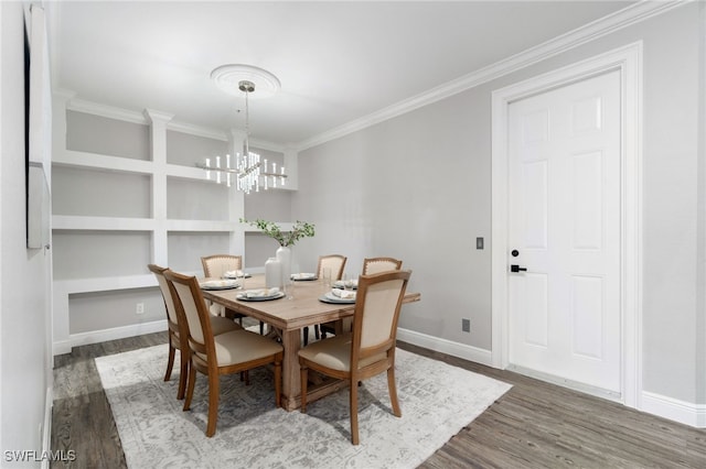 dining room featuring ornamental molding, hardwood / wood-style floors, and a notable chandelier