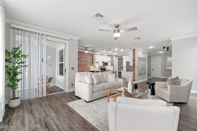 living room with ceiling fan, hardwood / wood-style flooring, and ornamental molding