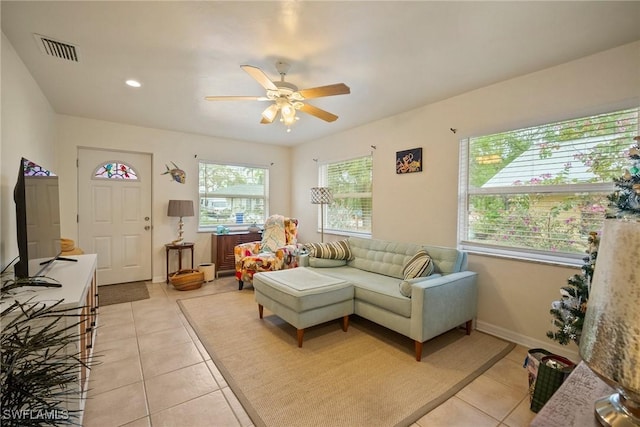 tiled living room featuring plenty of natural light and ceiling fan