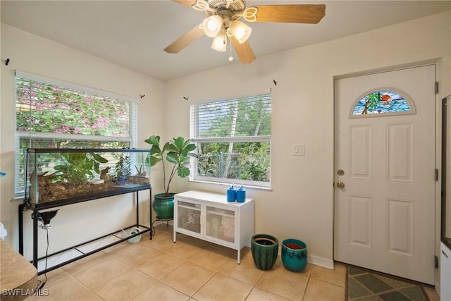 foyer with ceiling fan and light tile patterned flooring