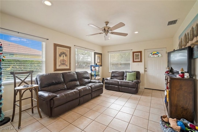 tiled living room featuring ceiling fan