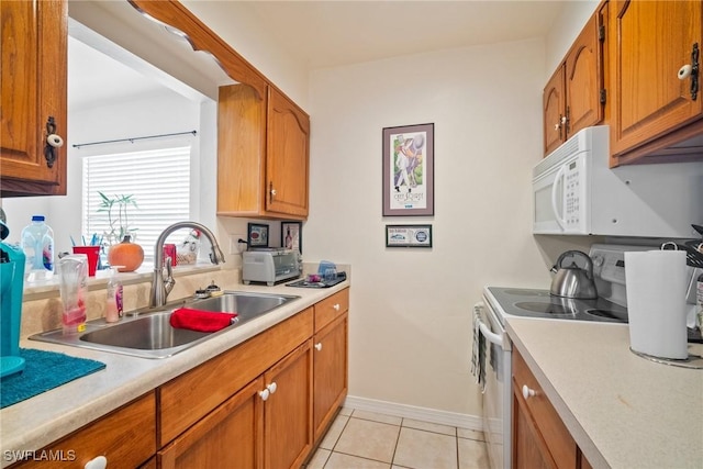 kitchen featuring sink, light tile patterned floors, and electric range oven