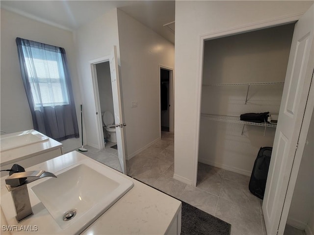 bathroom with tile patterned floors, vanity, and toilet