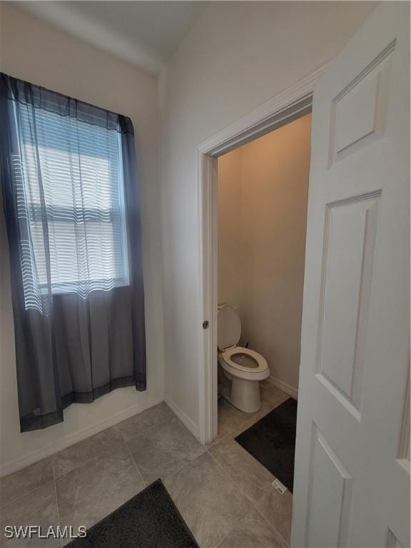 bathroom with tile patterned floors and toilet