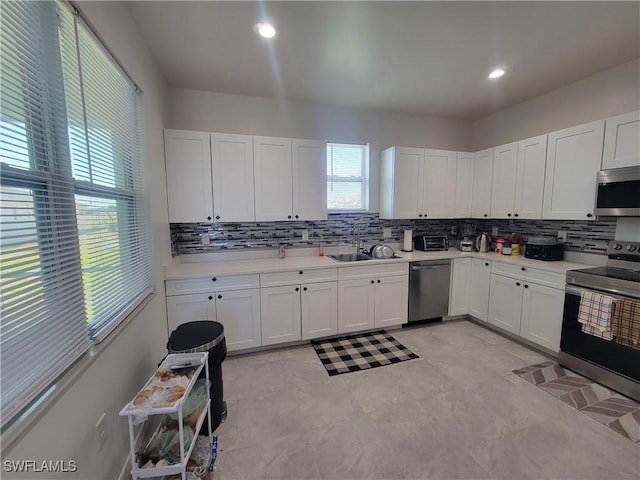 kitchen featuring sink, white cabinets, and stainless steel appliances