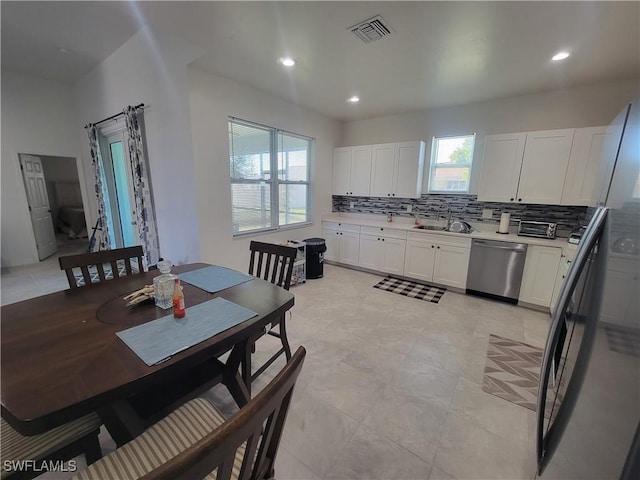 tiled dining room featuring sink