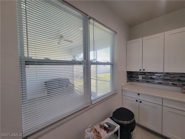 kitchen featuring white cabinetry and backsplash