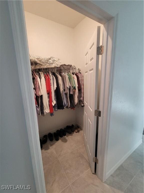 spacious closet featuring light tile patterned flooring