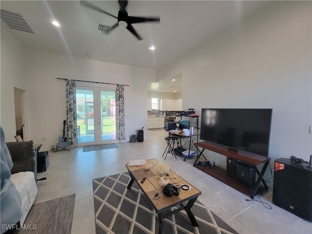 living room featuring ceiling fan and french doors