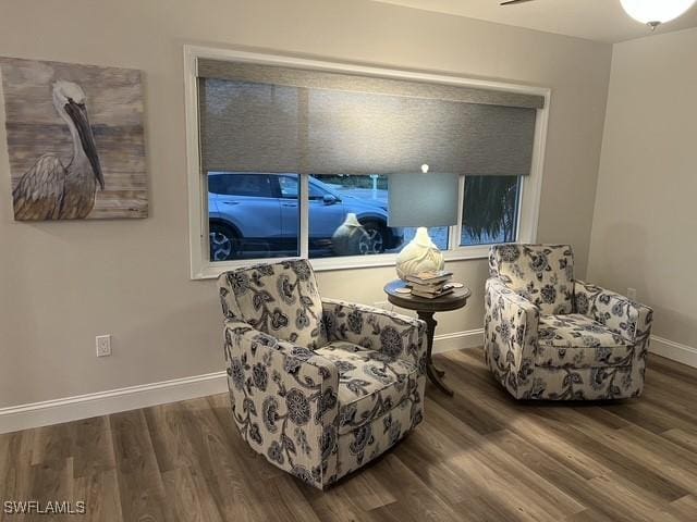 living area featuring hardwood / wood-style floors and ceiling fan