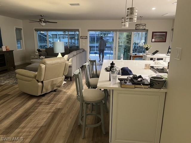 dining space featuring wood-type flooring and ceiling fan