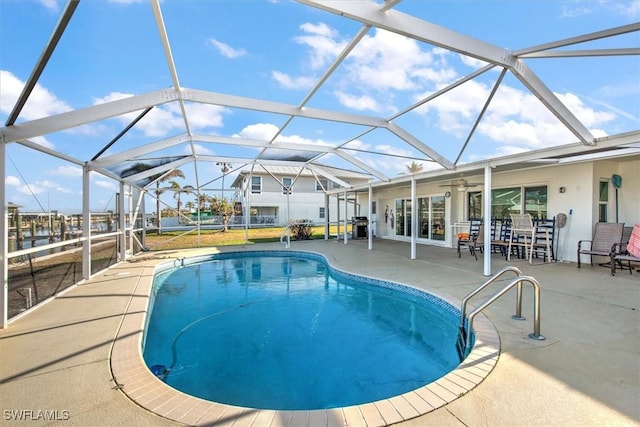 view of swimming pool featuring a patio and a lanai