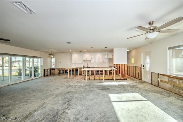 unfurnished living room with ceiling fan