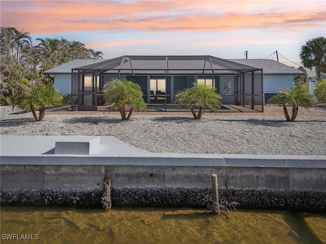 back house at dusk with a lanai