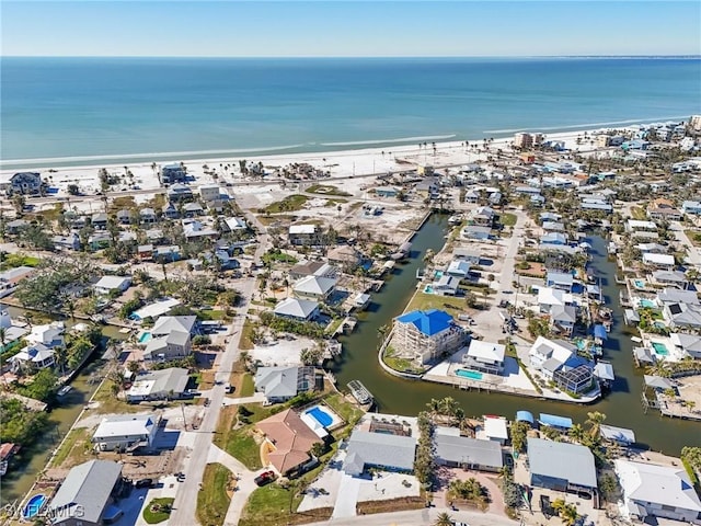 drone / aerial view featuring a water view and a beach view