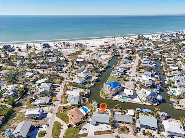 birds eye view of property featuring a water view and a view of the beach