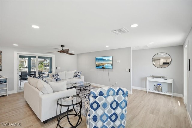 living room featuring ceiling fan and light wood-type flooring