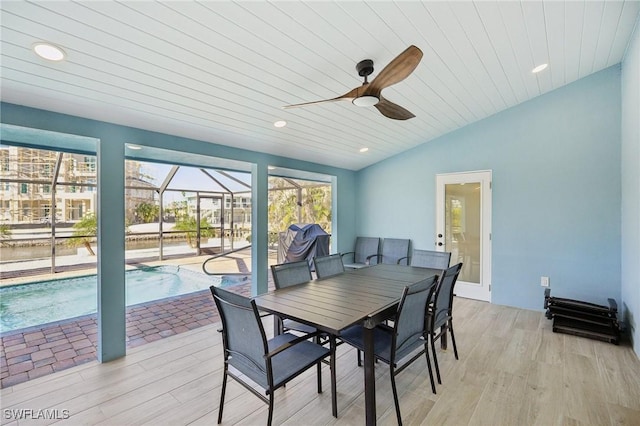 dining area with ceiling fan, vaulted ceiling, wood ceiling, and light hardwood / wood-style flooring