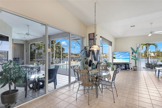 tiled dining space with lofted ceiling and ceiling fan