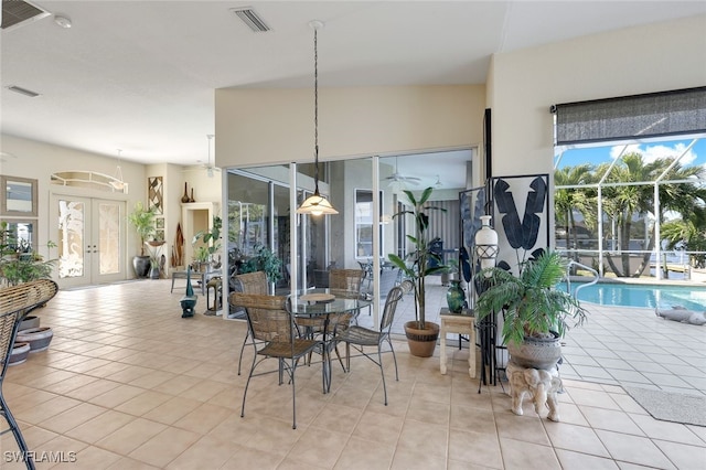 tiled dining area featuring a healthy amount of sunlight and french doors