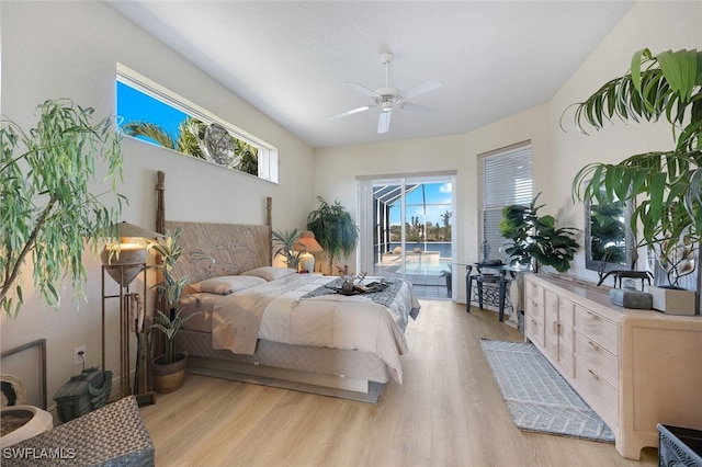 bedroom featuring access to outside, light hardwood / wood-style floors, and ceiling fan